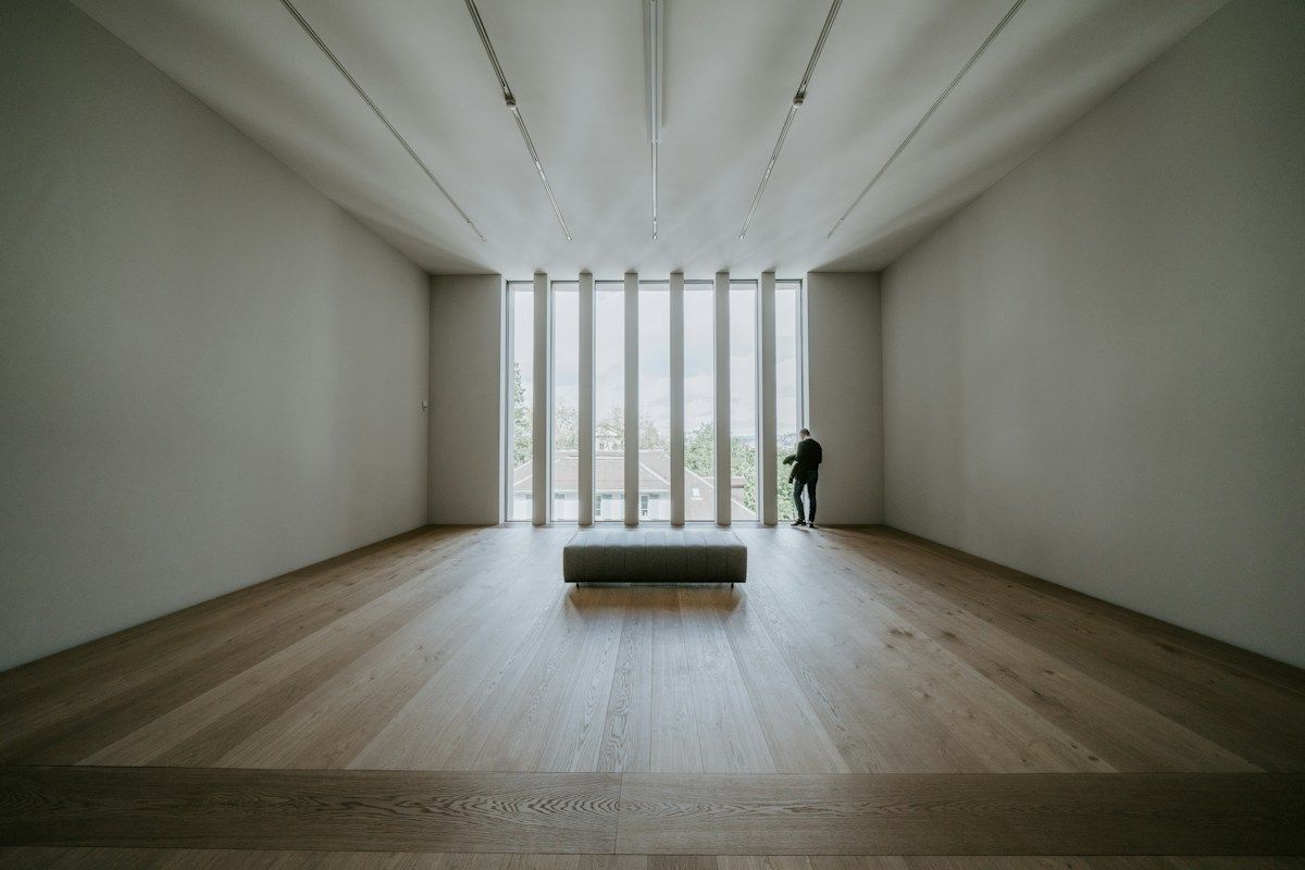 Quiet museum gallery with a lone visitor