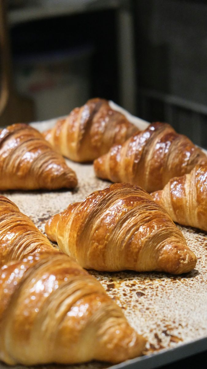 Freshly baked croissants on a tray