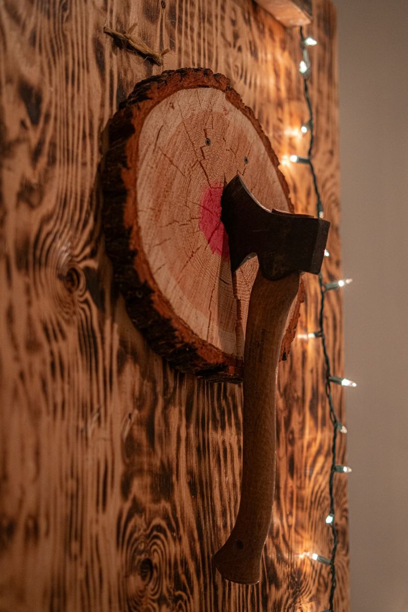 Axe stuck in a wooden target board