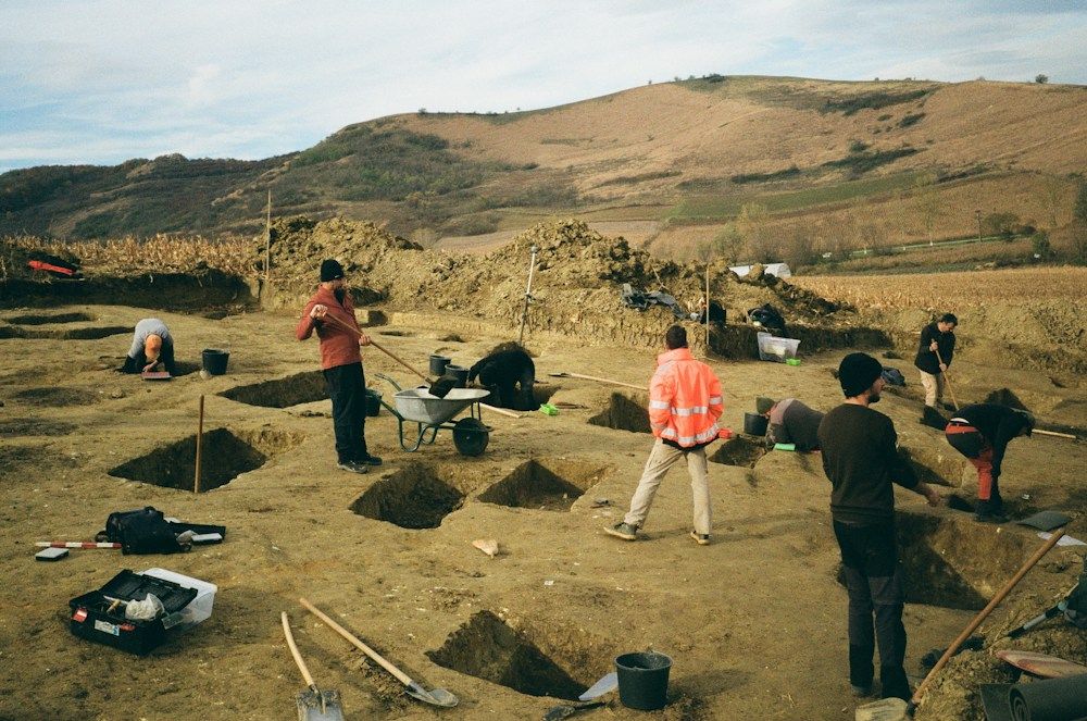 Excavation trenches and archaeological field workers