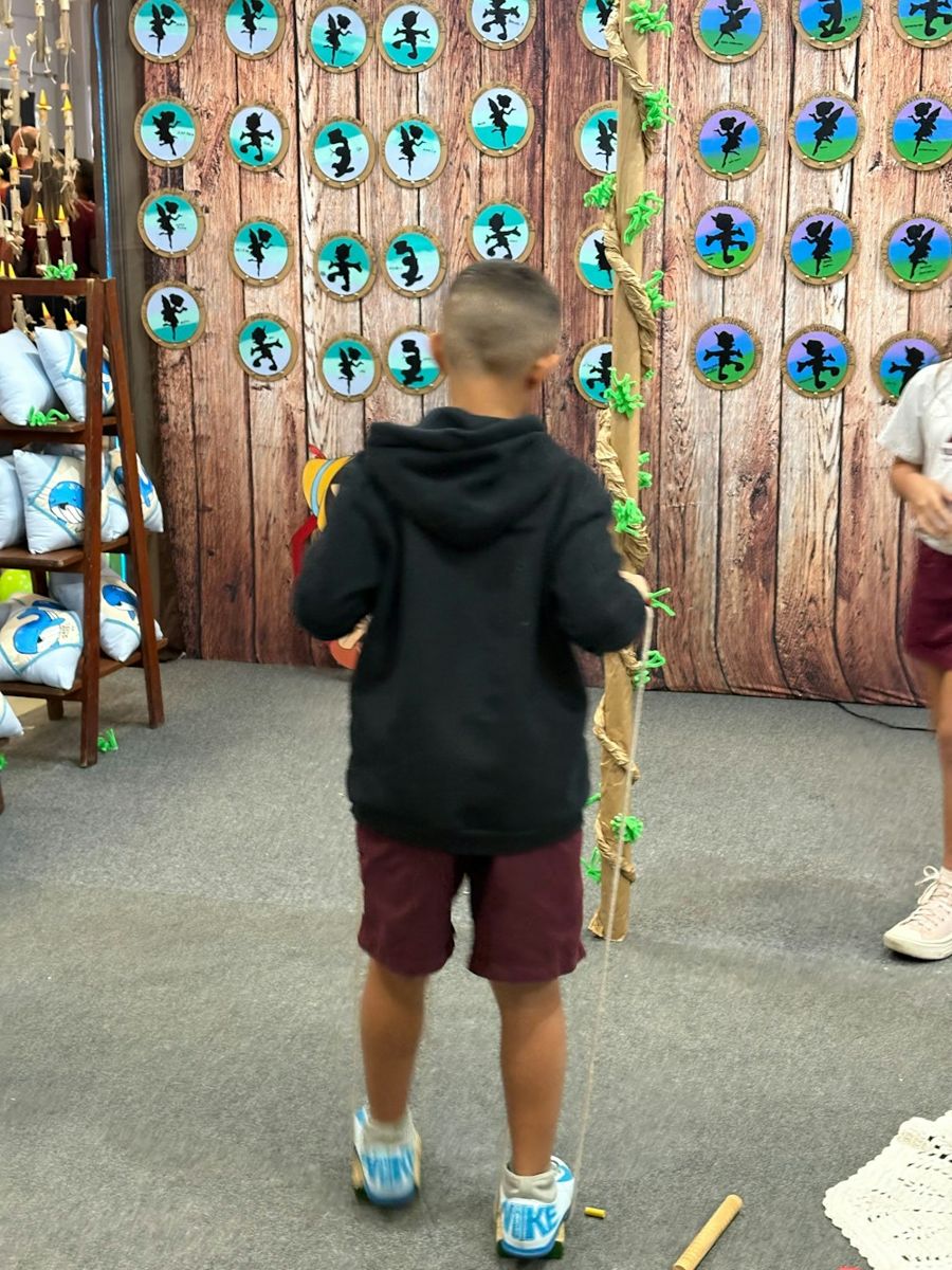 Boy playing a carnival game with beanbags