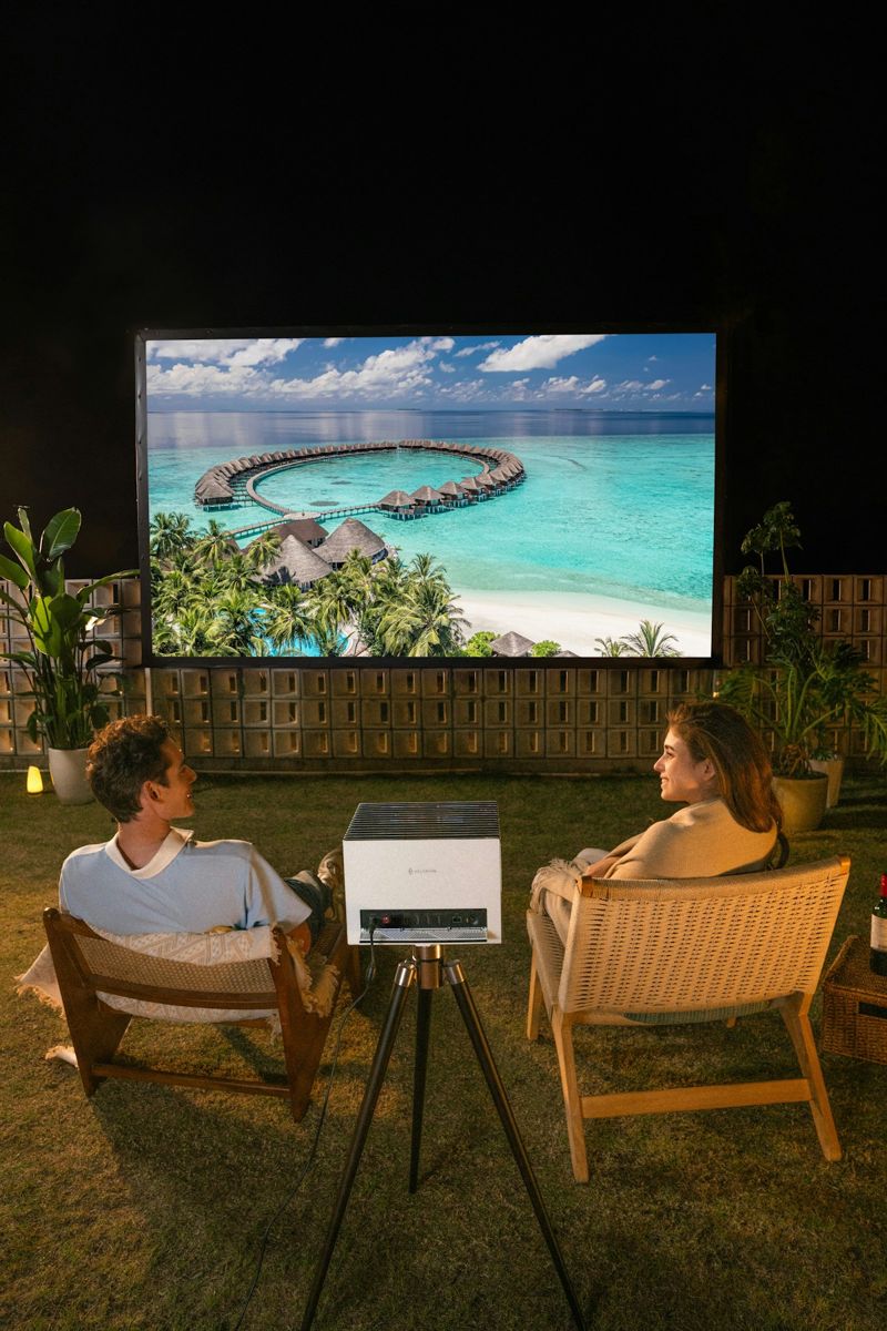 Couple watching an outdoor projector screen at night