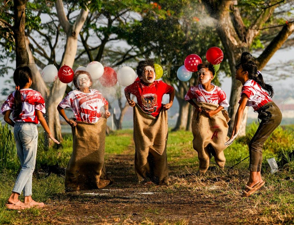 Children competing in a sack race outdoors