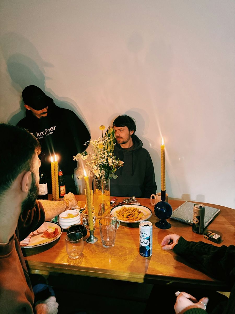 Friends around a table with food and candles