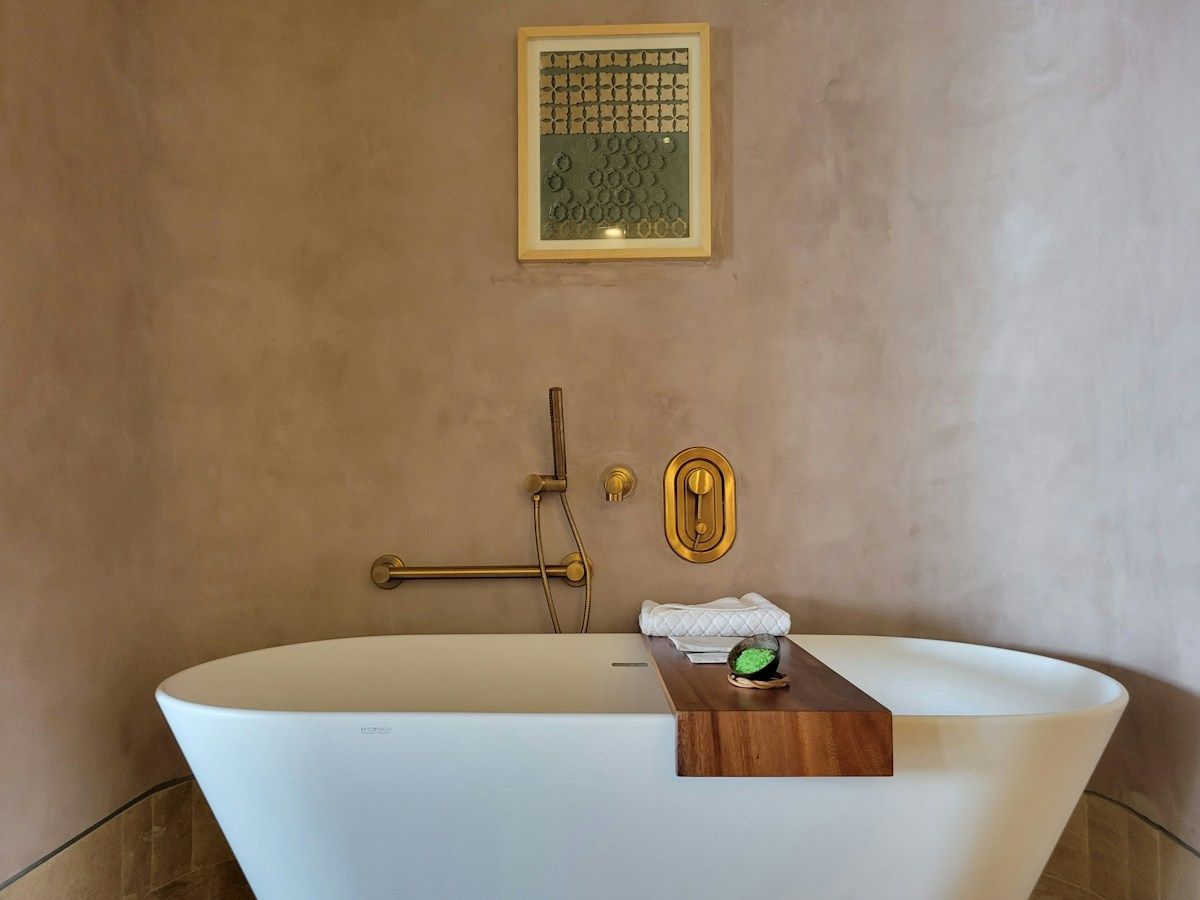 Bathtub with a wooden tray and folded towel