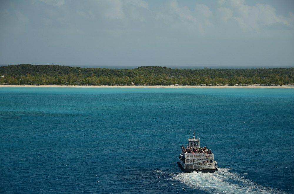 Passenger ferry traveling over turquoise ocean water
