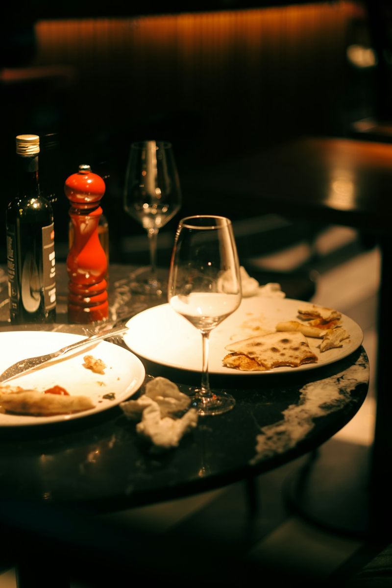 Food plates and wine on a dining table