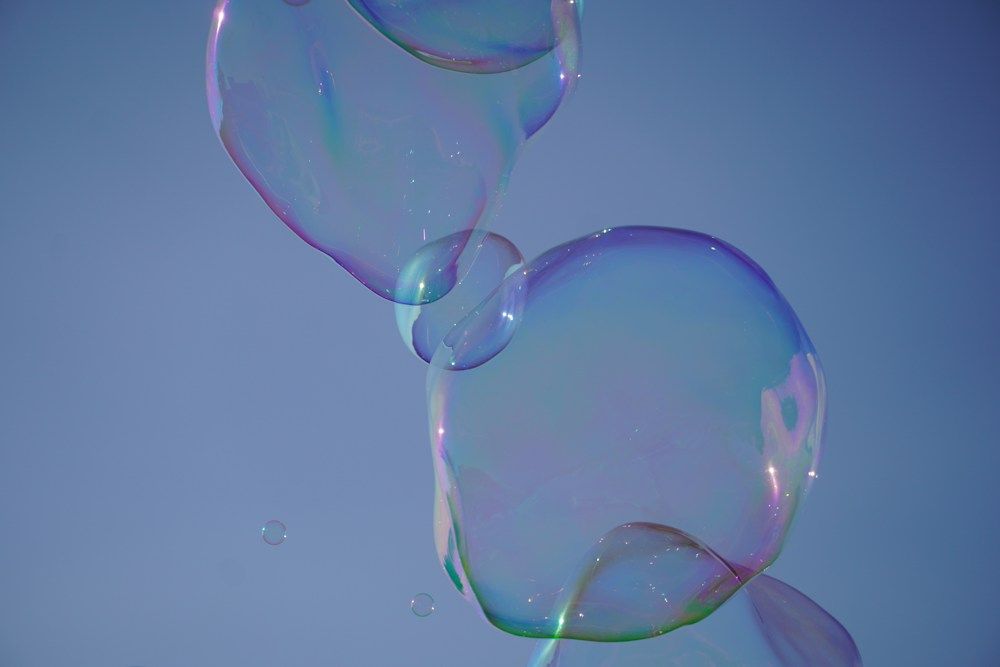 soap bubbles floating in the air on a sunny day