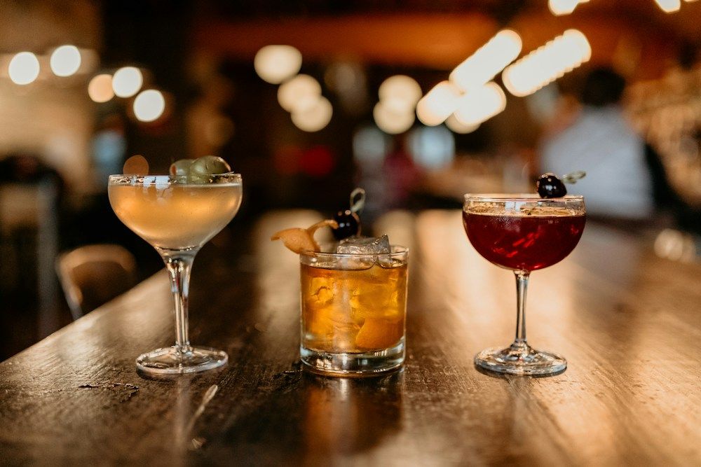 Craft cocktails under warm bar lighting