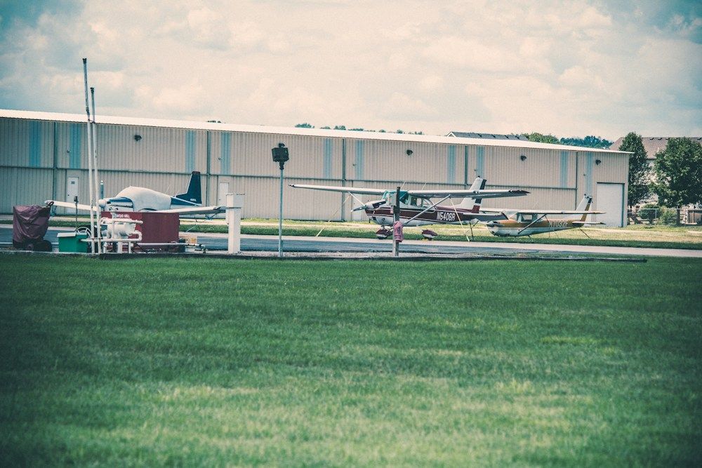 Small propeller plane outside an airport hangar