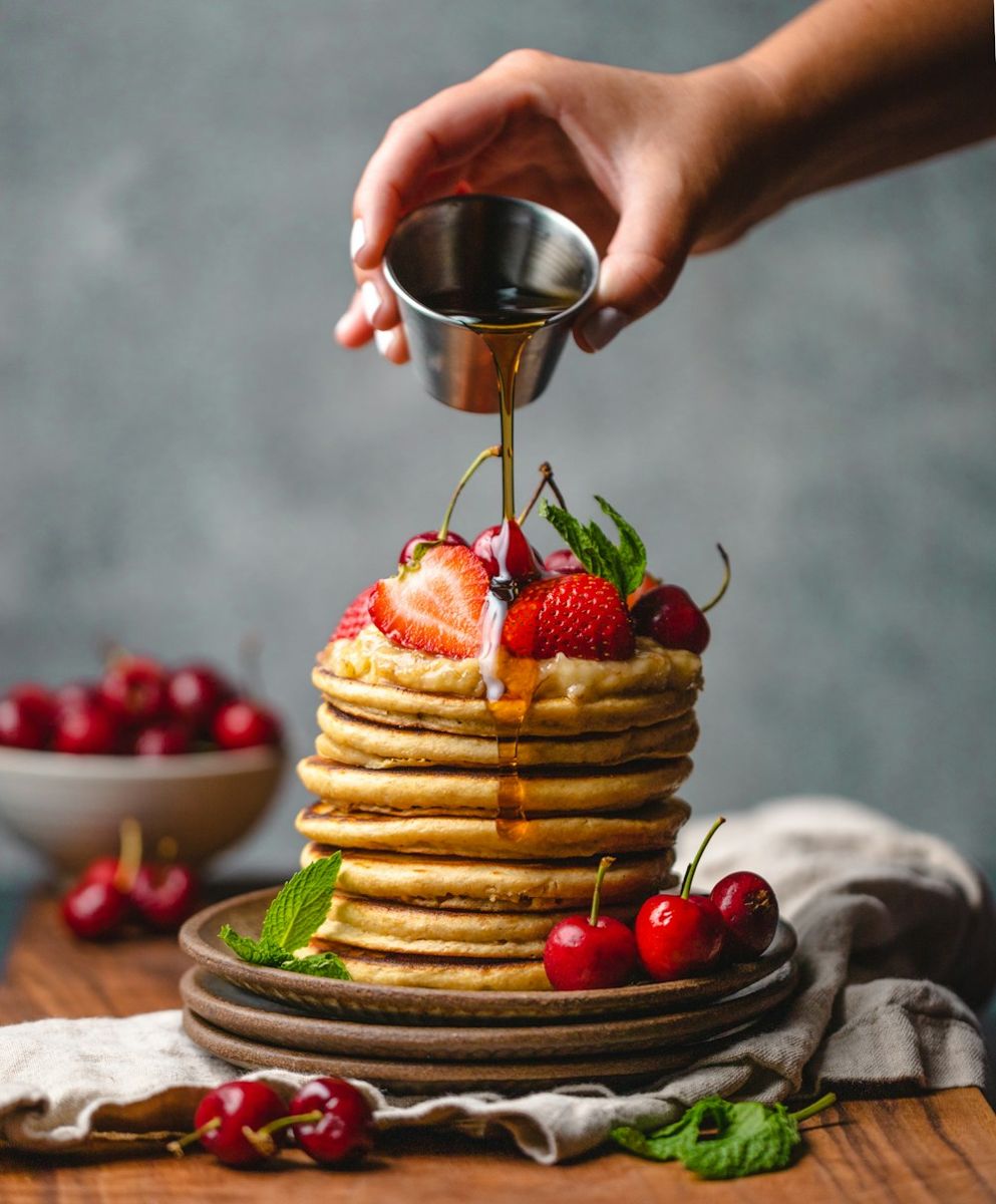 Syrup poured over homemade pancakes