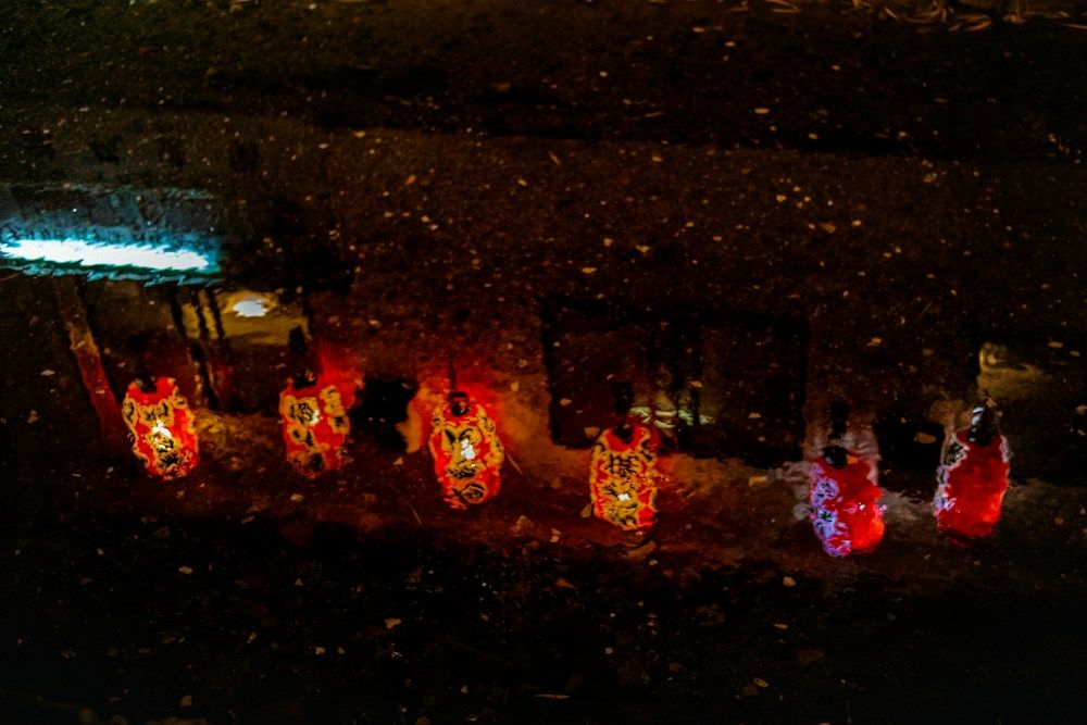 People walking with lanterns at night