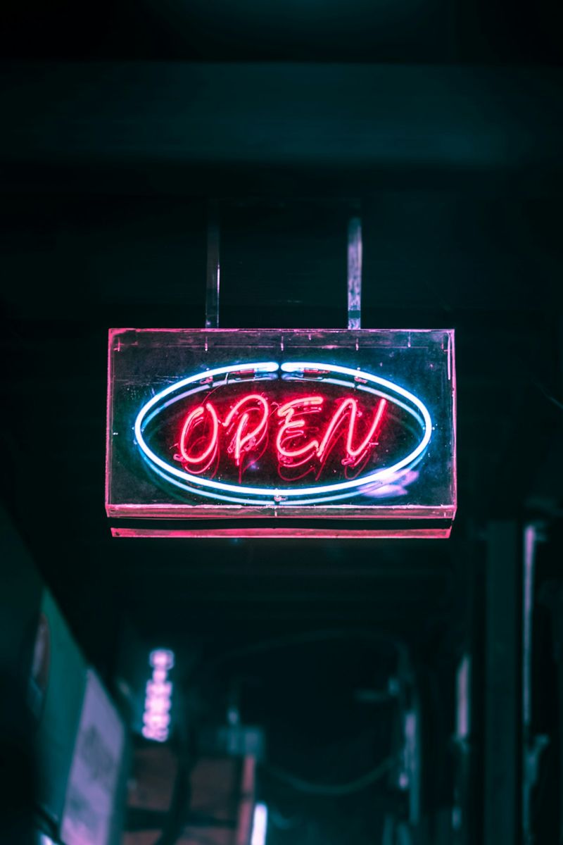 Red OPEN neon sign with a blue border