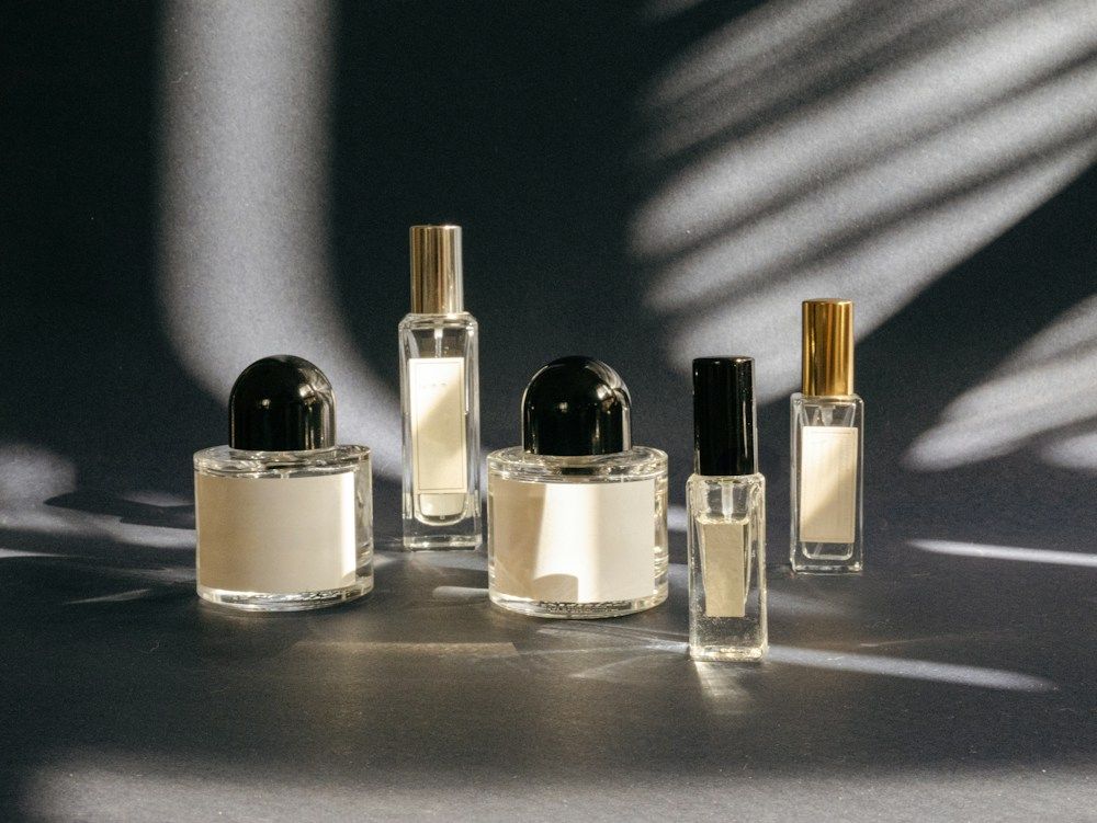 Five perfume bottles on a tabletop