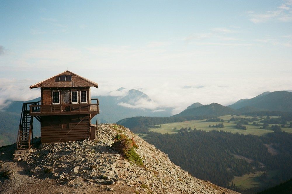 Wooden lookout tower on rocky forest mountain