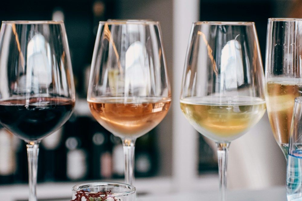 Four glasses of different wines on a table