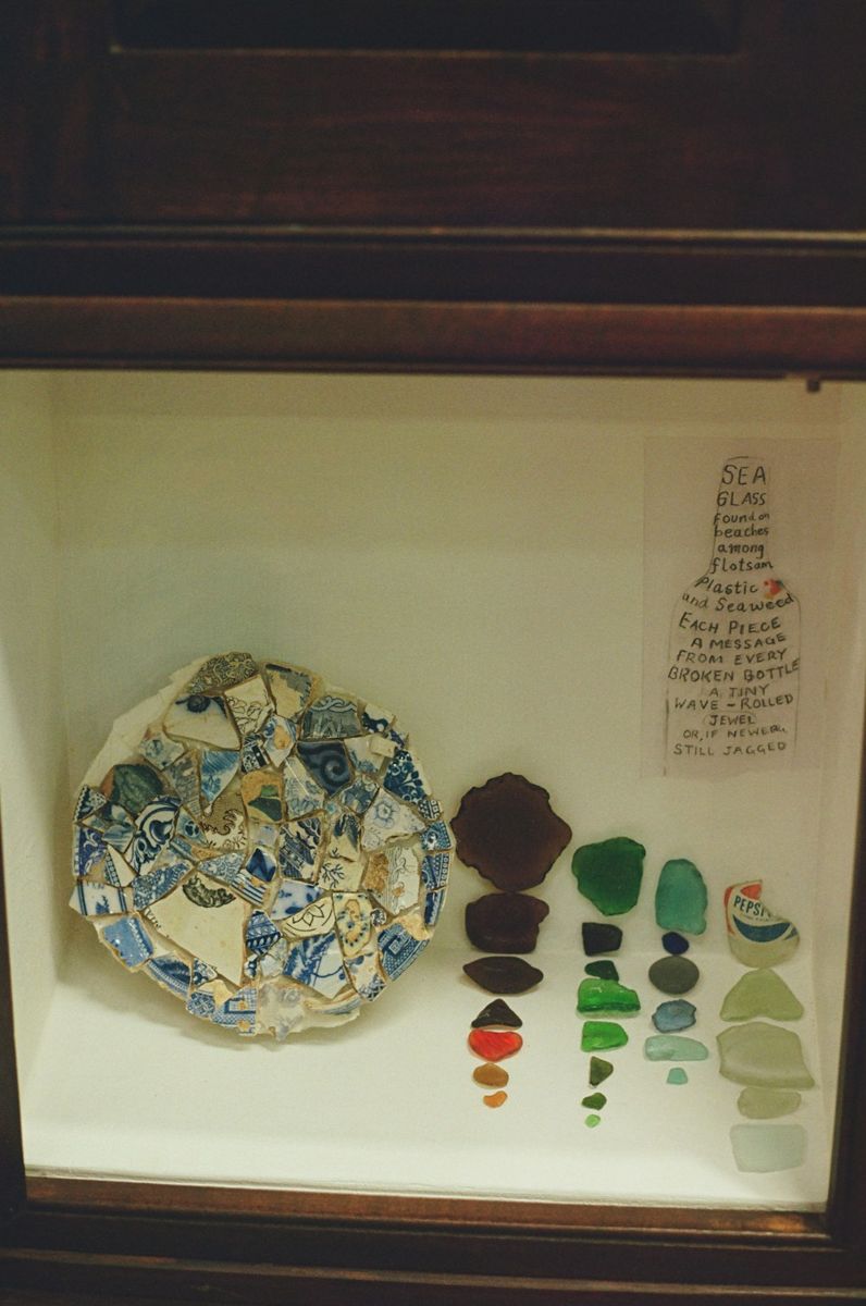 Pottery fragments and sea glass laid out for inspection
