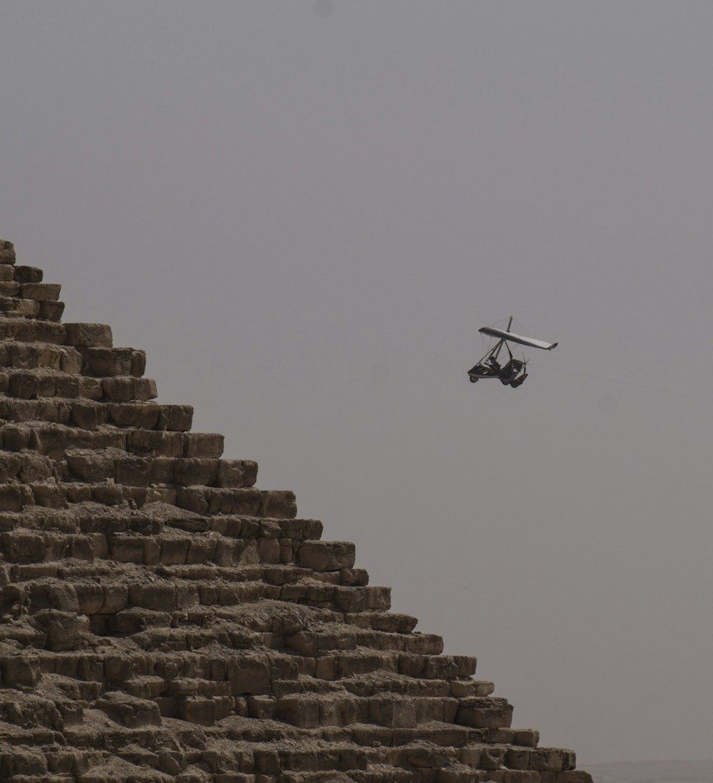 Ultralight aircraft flying near an Egyptian pyramid