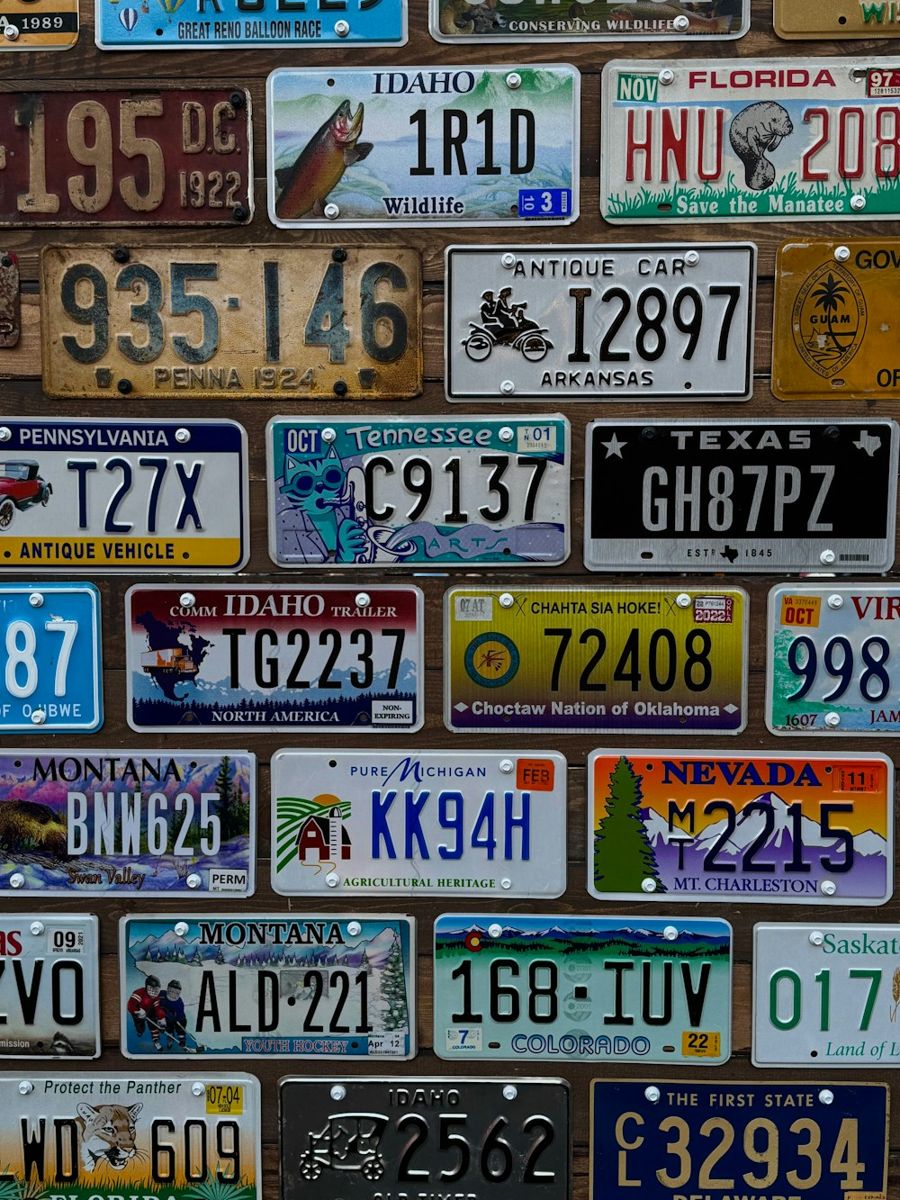 Wall covered with license plates from different regions