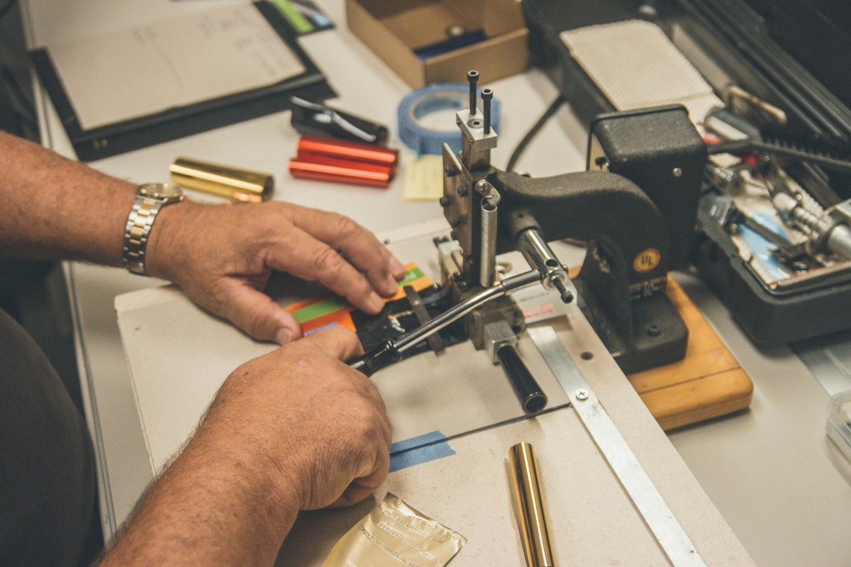 Hands operating book-making tools