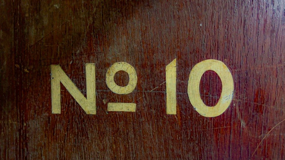 Hand painted No 10 lettering on an old wooden door