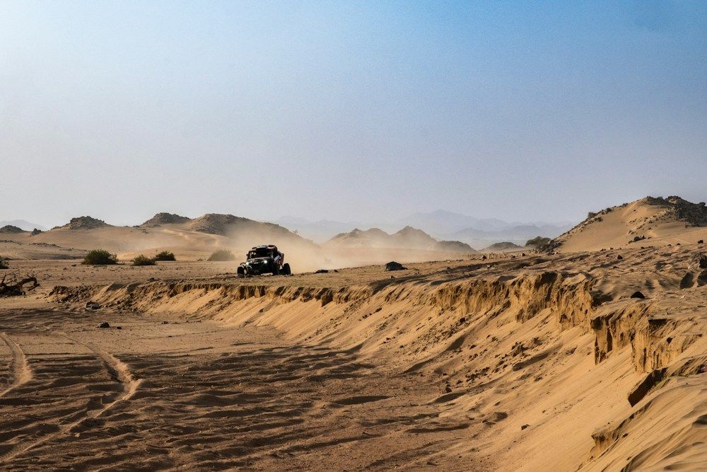 Buggy driving through desert dust