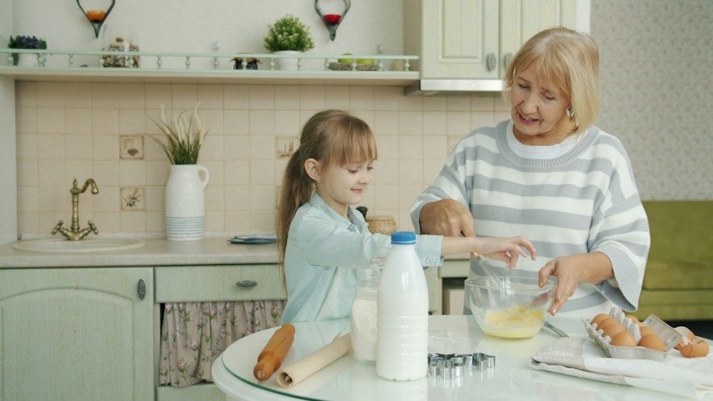 Grandmother and child baking together in a kitchen