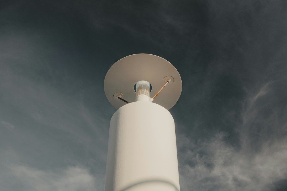 White weather station under stormy clouds