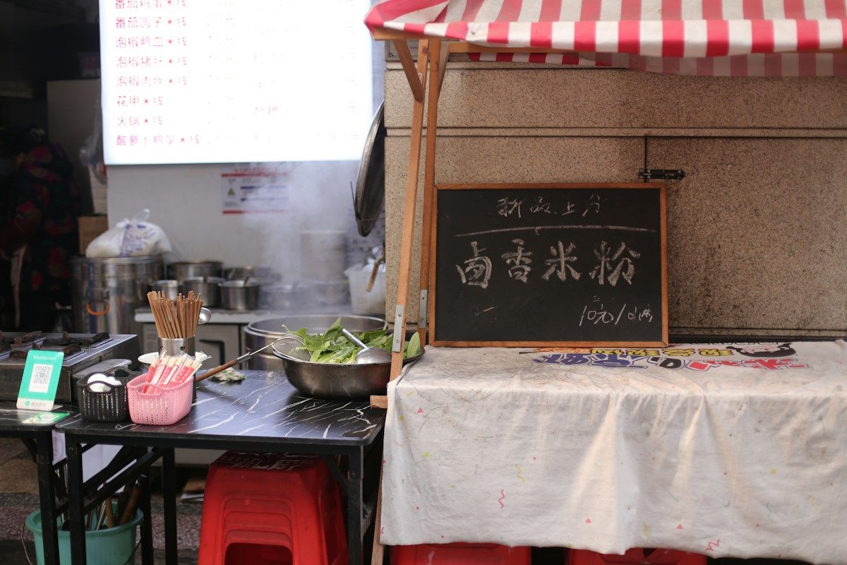 Street food kitchen with ingredients and a menu board