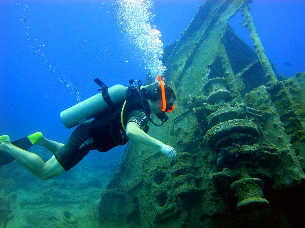 Scuba diver exploring a submerged shipwreck