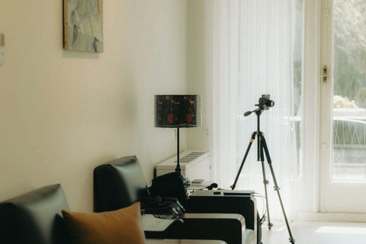 A camera on a tripod in a bright living room