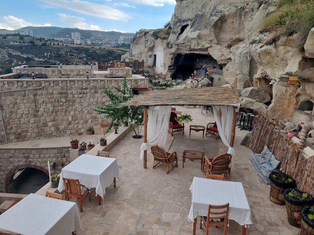 Restaurant tables in a stone cave hotel in Cappadocia.