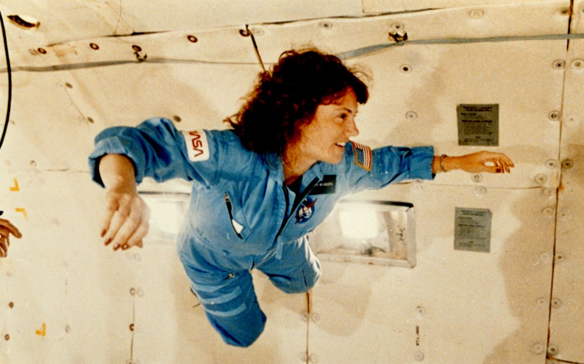 Christa McAuliffe floats inside a NASA KC-135 during parabolic flight training