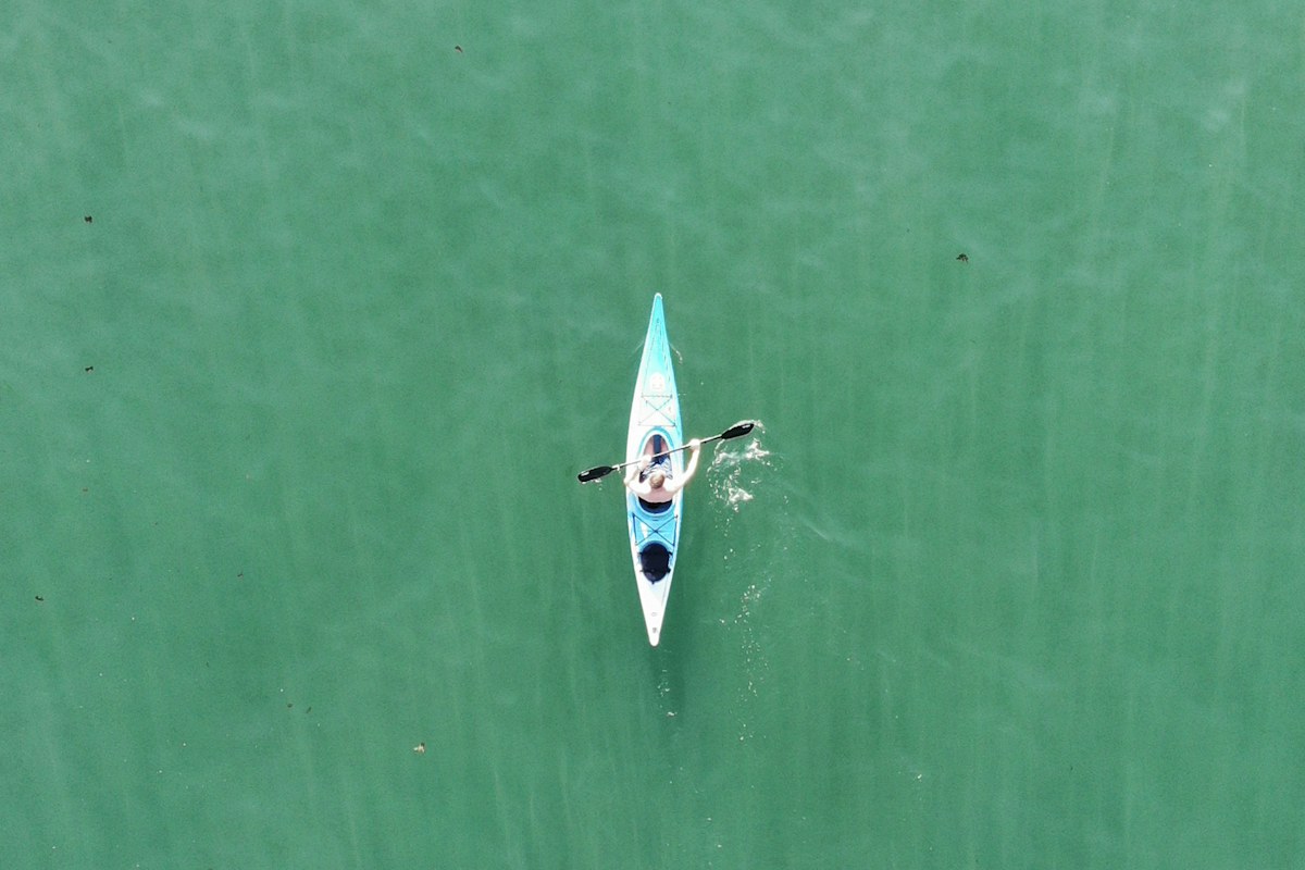A kayaker on clear blue water